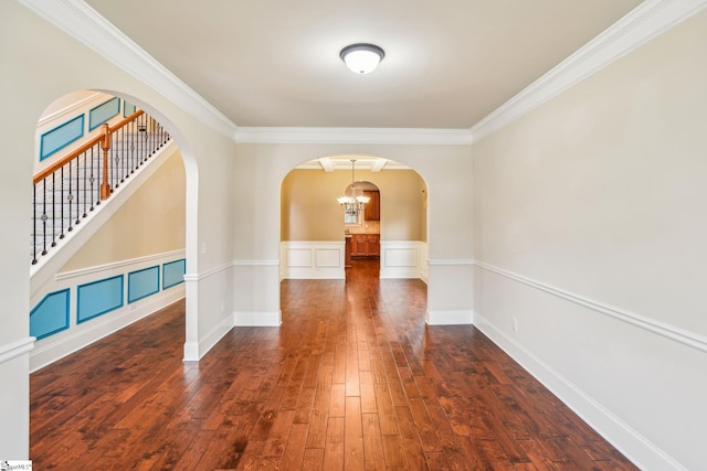 interior space featuring ornamental molding, dark hardwood / wood-style floors, and a chandelier