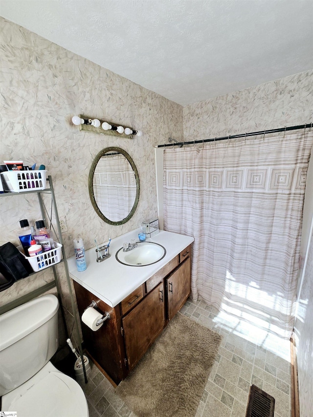 bathroom with vanity, a shower with shower curtain, and toilet