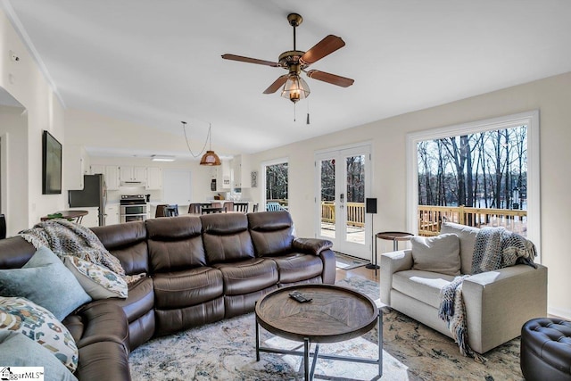 living room featuring lofted ceiling, ceiling fan, and french doors