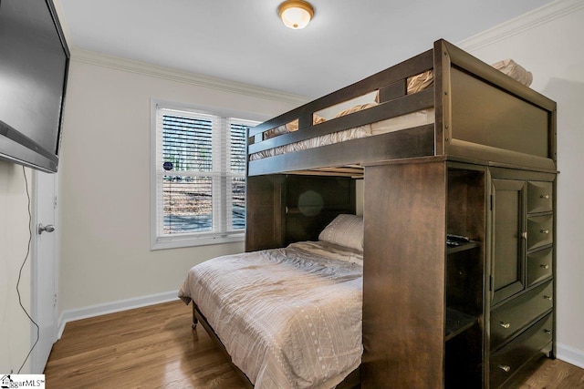 bedroom featuring crown molding and wood-type flooring