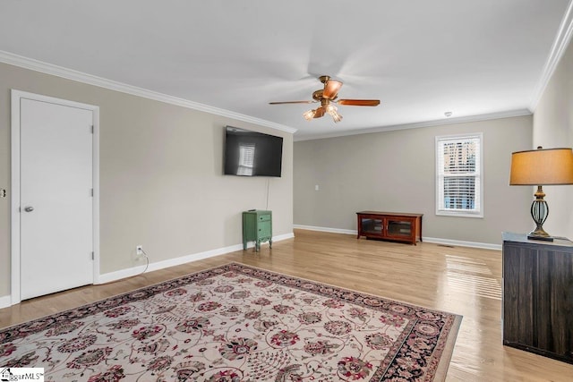 living room featuring crown molding, ceiling fan, and light wood-type flooring