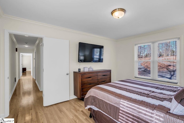 bedroom featuring crown molding and light hardwood / wood-style floors