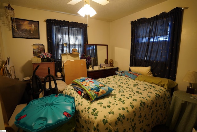 bedroom featuring ceiling fan and a textured ceiling