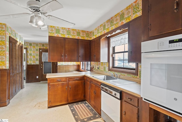 kitchen with dishwasher, ceiling fan, and kitchen peninsula