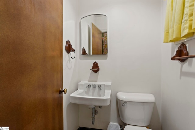 bathroom featuring toilet and sink