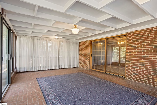 unfurnished sunroom with coffered ceiling and beam ceiling