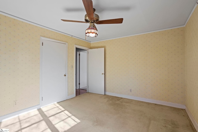 unfurnished bedroom with crown molding, light colored carpet, and ceiling fan