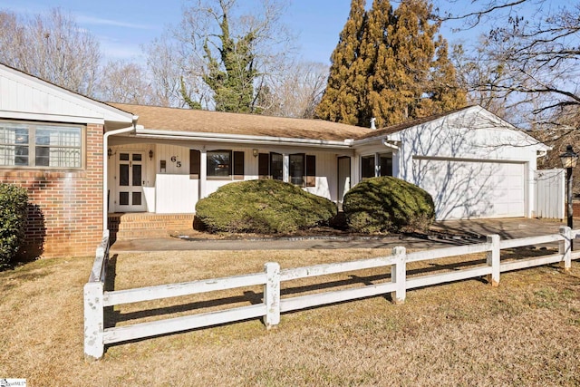 ranch-style home with a garage and a front yard