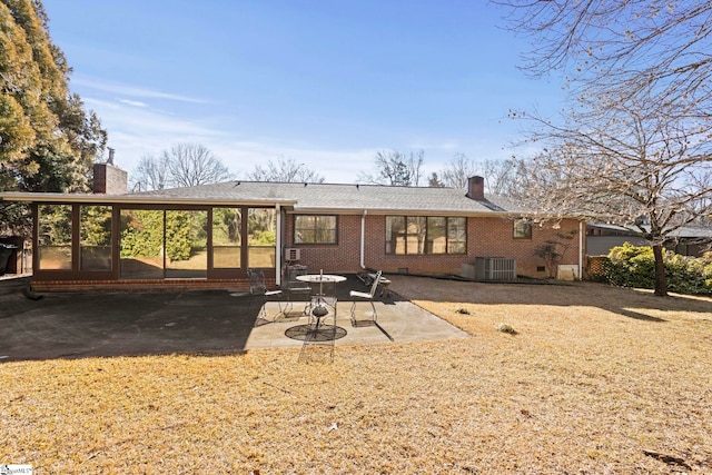 back of house featuring cooling unit, a sunroom, and a patio