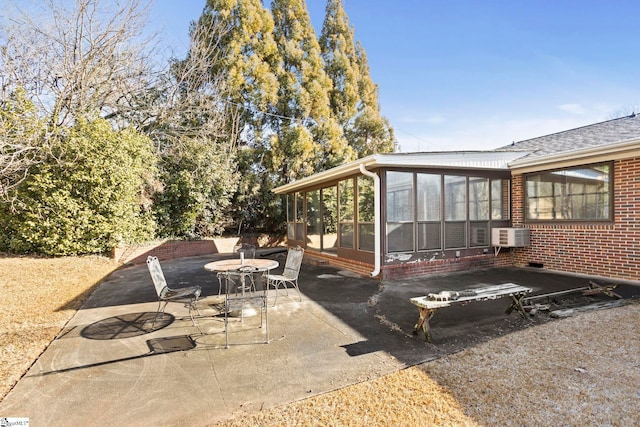 view of patio featuring cooling unit and a sunroom