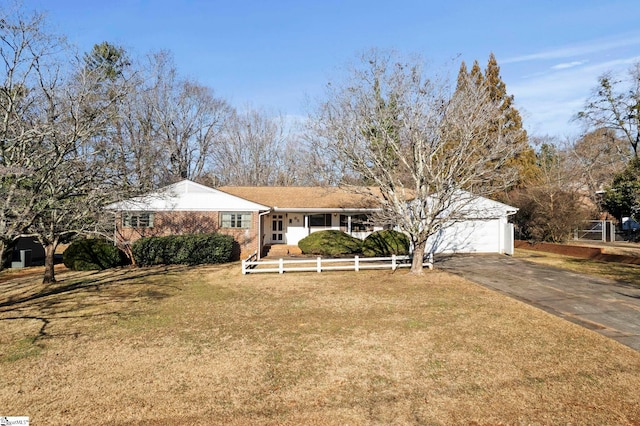 ranch-style house with a garage and a front yard