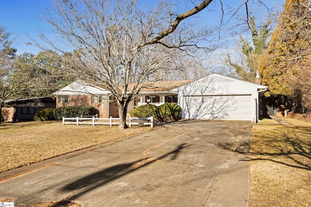 ranch-style home featuring a garage and a front yard