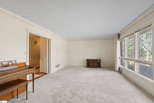 interior space with crown molding and light colored carpet