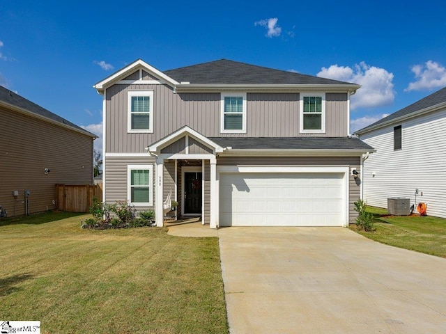 view of front of home with a garage, a front yard, and central air condition unit