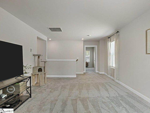 unfurnished living room featuring light carpet