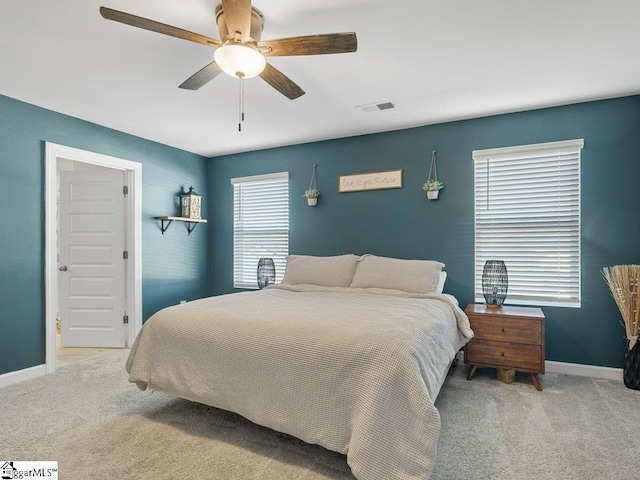 bedroom with light carpet and ceiling fan