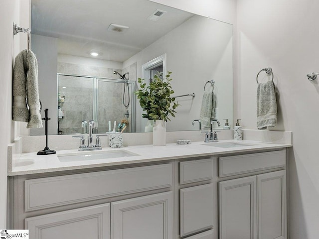 bathroom with walk in shower and vanity