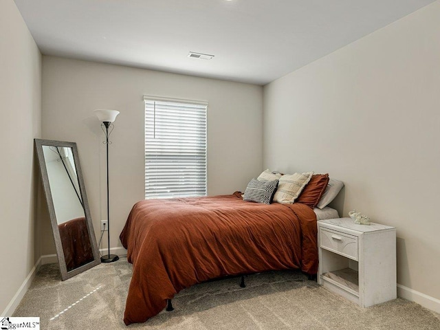 bedroom with light colored carpet