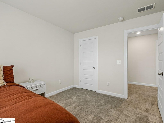 bedroom featuring light colored carpet