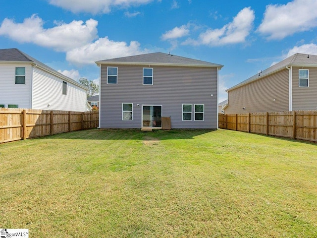 rear view of house with a lawn