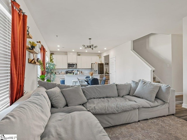 living room with an inviting chandelier and wood-type flooring