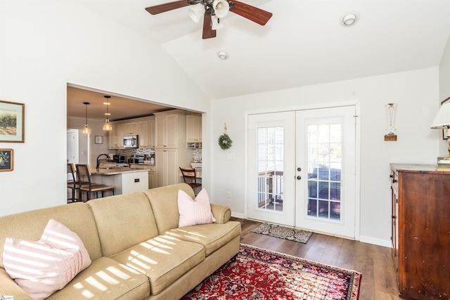 living room with dark wood-type flooring, french doors, lofted ceiling, sink, and ceiling fan