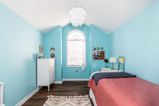 bedroom with lofted ceiling, a notable chandelier, and dark hardwood / wood-style floors