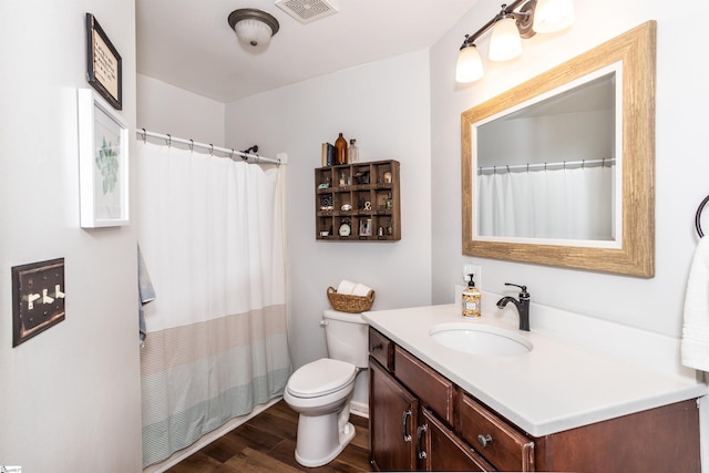 bathroom featuring vanity, hardwood / wood-style floors, toilet, and a shower with shower curtain