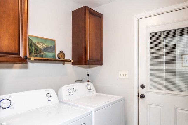 washroom featuring cabinets and washing machine and clothes dryer