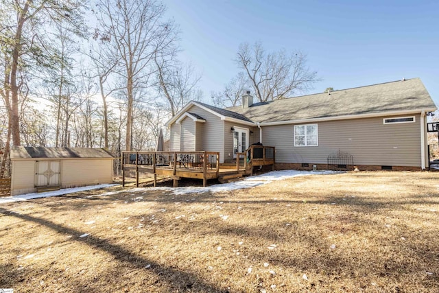 back of property featuring a deck, a shed, and a lawn