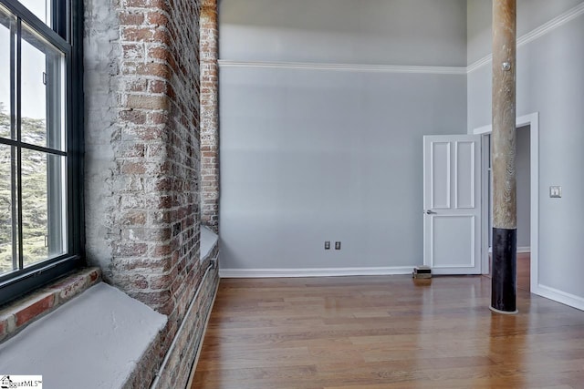 interior space with hardwood / wood-style floors and a high ceiling