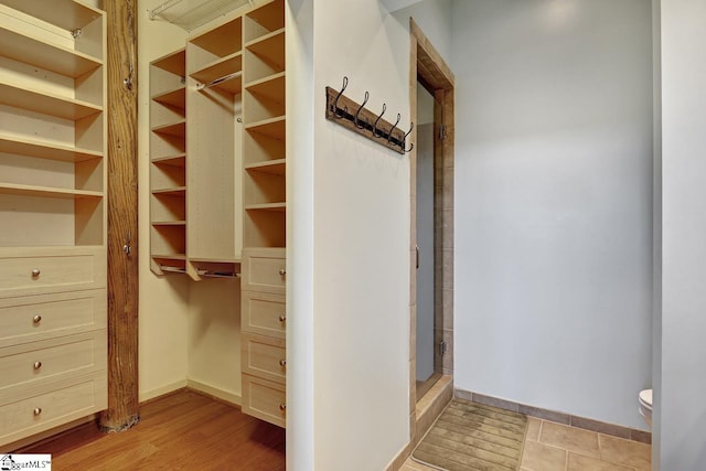 walk in closet with light wood-type flooring