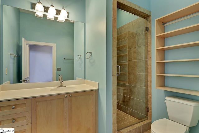 bathroom with an enclosed shower, vanity, and toilet