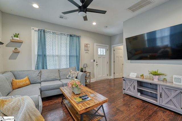 living room featuring dark hardwood / wood-style flooring and ceiling fan