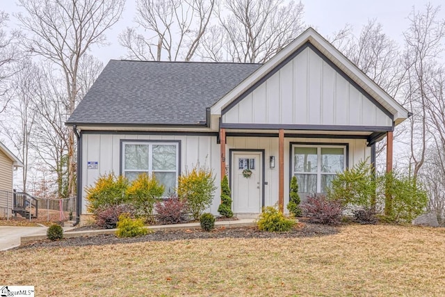 view of front of house featuring a front yard and covered porch