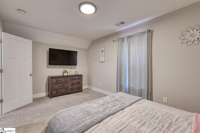 carpeted bedroom featuring lofted ceiling