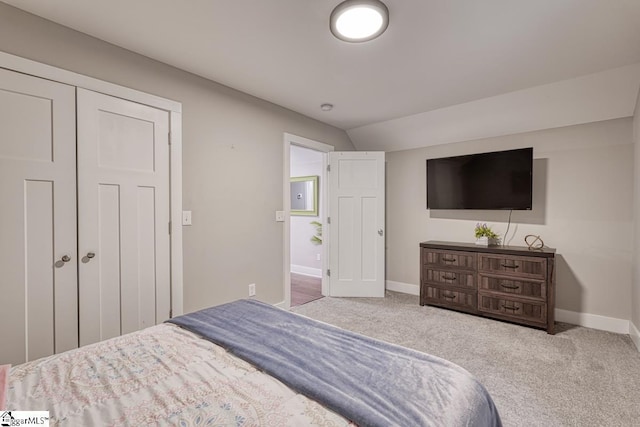 bedroom featuring vaulted ceiling and carpet floors