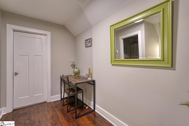 corridor featuring vaulted ceiling and dark hardwood / wood-style floors