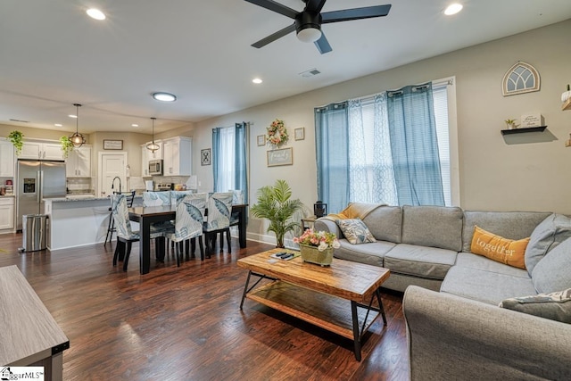 living room with sink, dark hardwood / wood-style floors, and ceiling fan