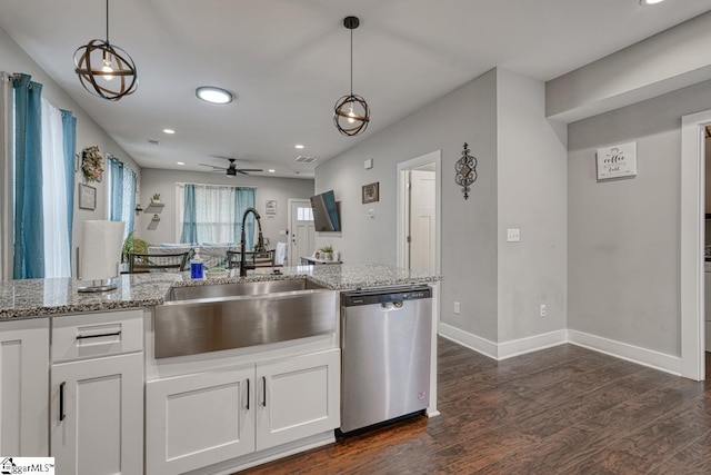 kitchen featuring sink, light stone countertops, white cabinets, decorative light fixtures, and stainless steel dishwasher