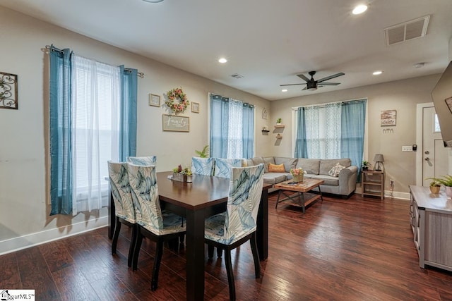 dining space with dark wood-type flooring and ceiling fan