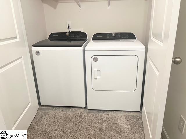 clothes washing area featuring washer and clothes dryer