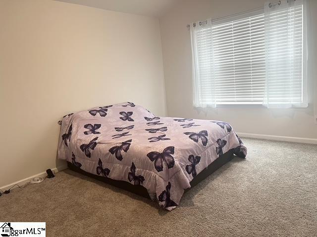 bedroom with vaulted ceiling and carpet