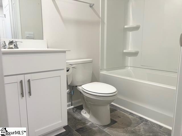 full bathroom with vanity, shower / washtub combination, and toilet