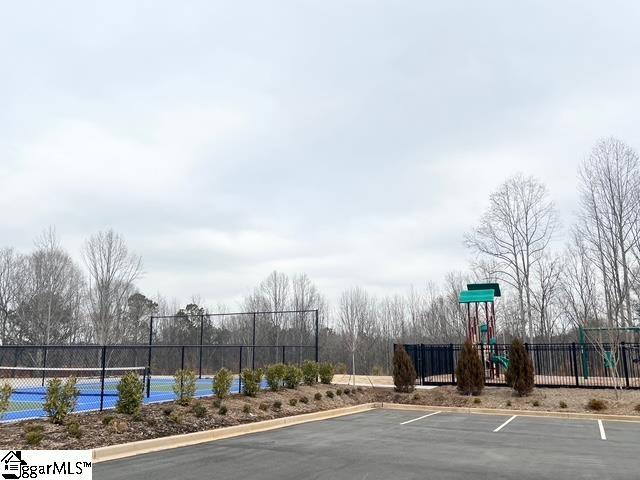 exterior space with a playground and tennis court