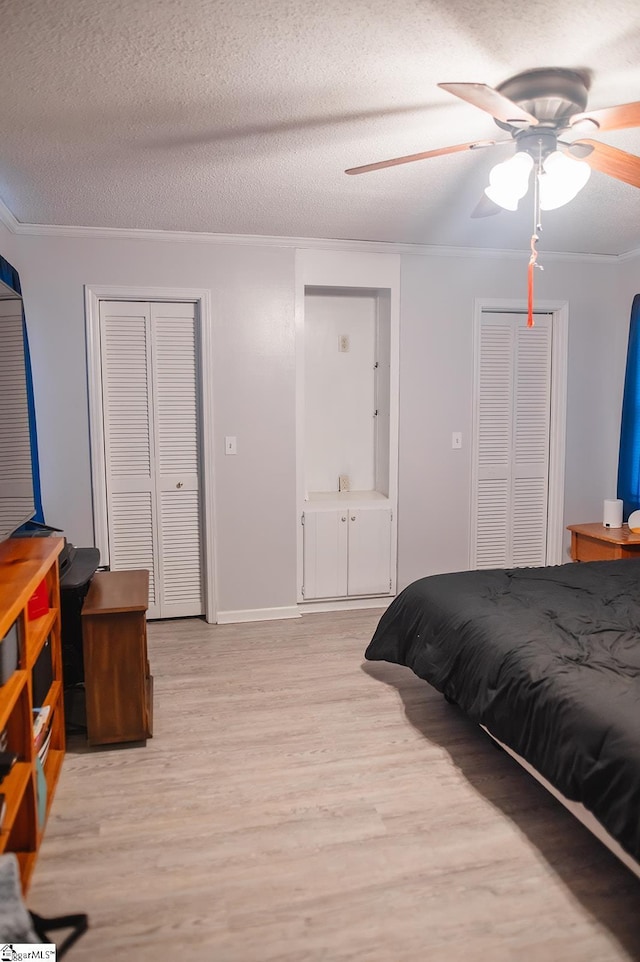 bedroom featuring crown molding, light hardwood / wood-style flooring, and a textured ceiling