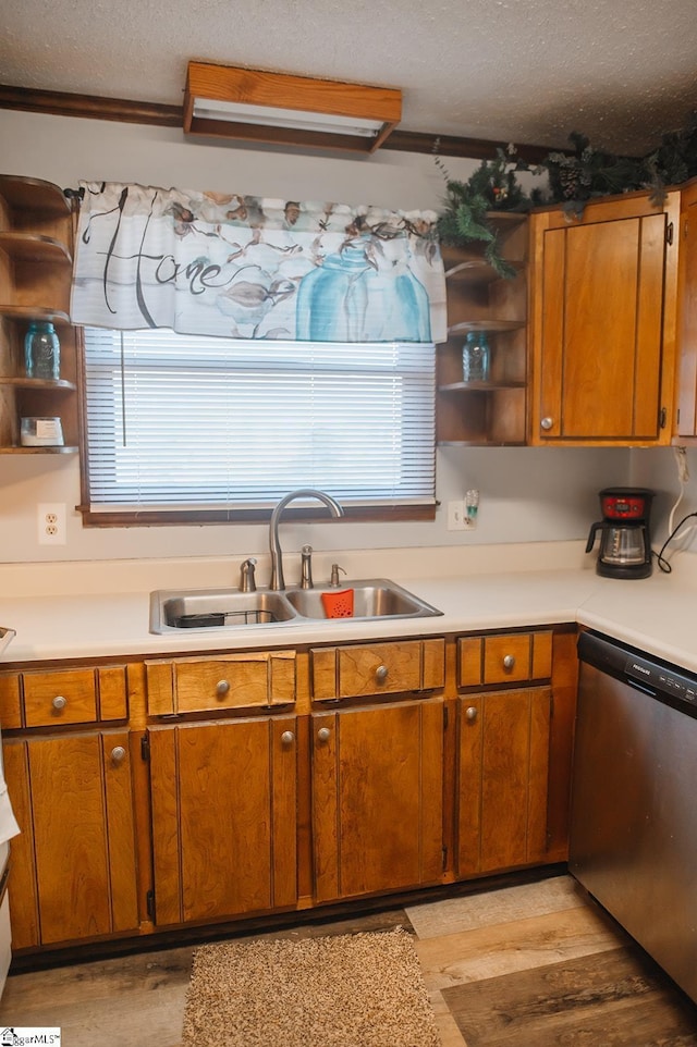 kitchen with dishwasher, plenty of natural light, sink, and a textured ceiling