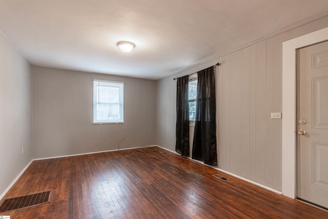 spare room with dark hardwood / wood-style flooring