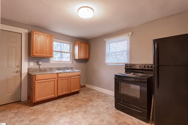 kitchen featuring sink and black appliances