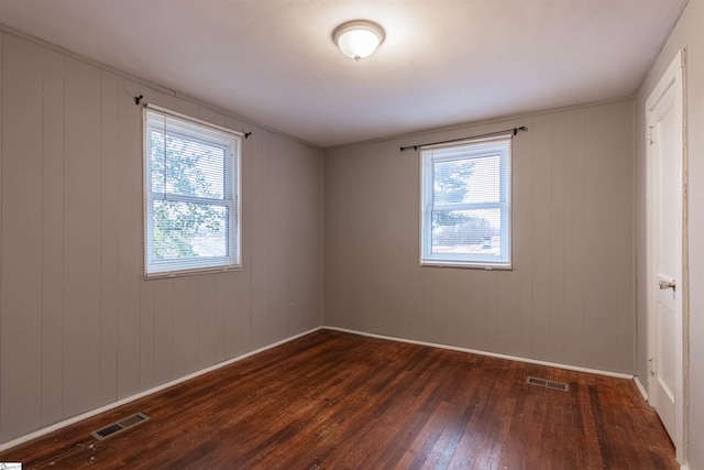 unfurnished room featuring dark hardwood / wood-style flooring